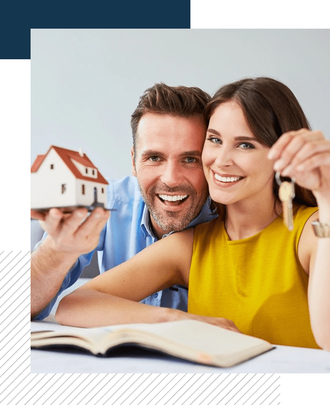 A man and woman holding keys to their new home.